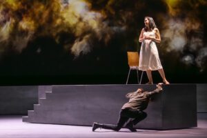 Opera scene from Castor et Pollux at the Grand Théâtre de Genève with dramatic lighting and minimal stage design