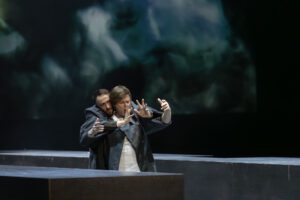 Opera scene from Castor et Pollux at the Grand Théâtre de Genève with dramatic lighting and minimal stage design