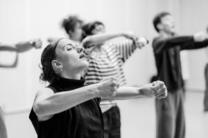 Contemporary dancer in motion during rehearsal in studio, black and white