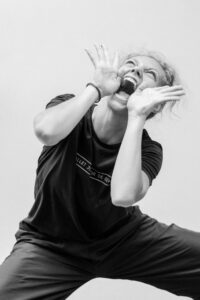Contemporary dancer in motion during rehearsal in studio, black and white