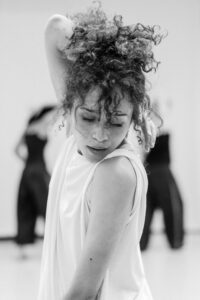 Contemporary dancer in motion during rehearsal in studio, black and white
