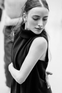 Contemporary dancer in motion during rehearsal in studio, black and white