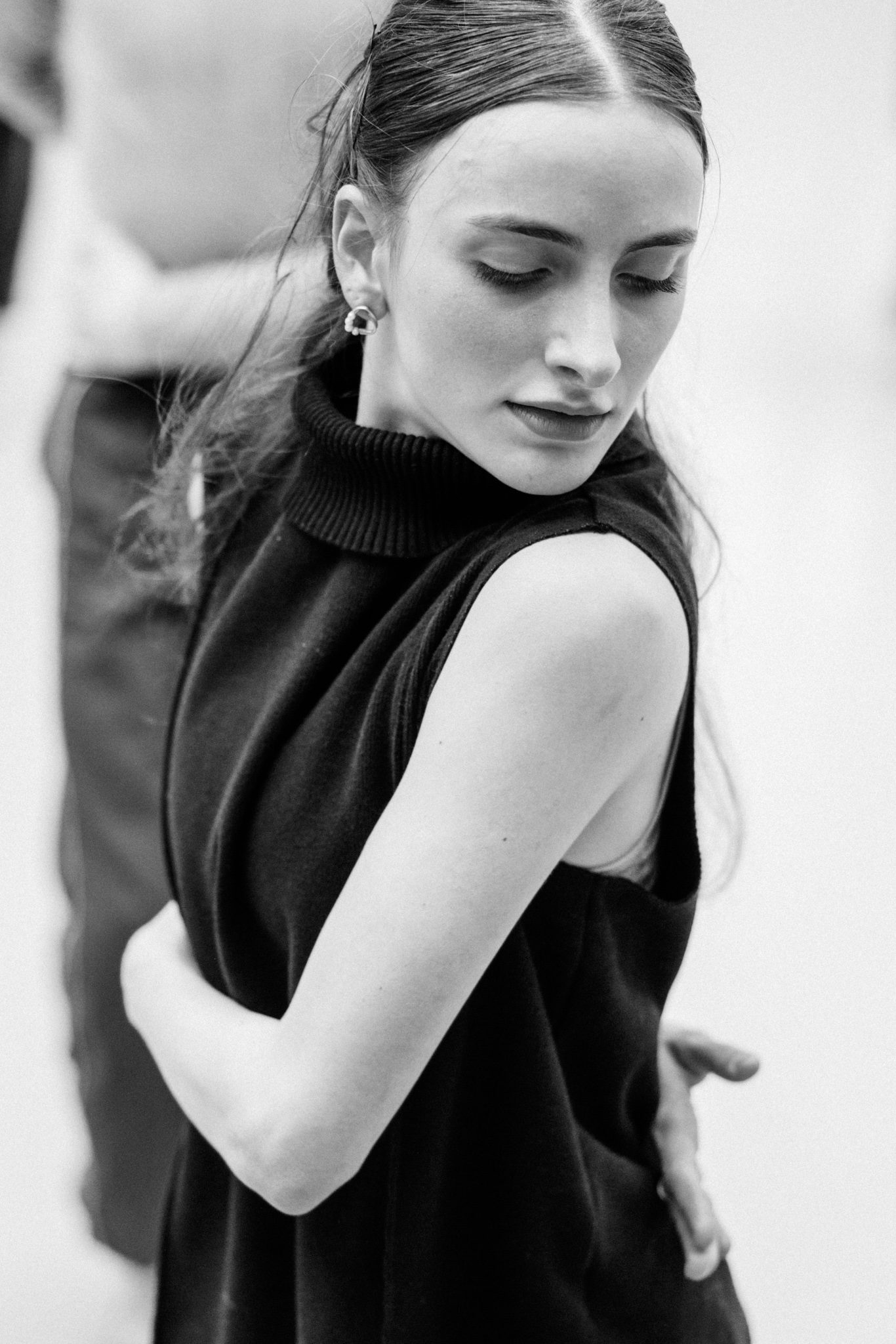 Contemporary dancer in motion during rehearsal in studio, black and white