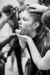 Dancer with focused expression in studio rehearsal, black and white