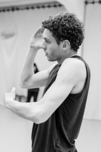 Contemporary dancer in motion during rehearsal in studio, black and white