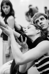 Dancer with focused expression in studio rehearsal, black and white