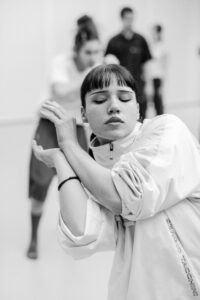 Contemporary dancer in motion during rehearsal in studio, black and white