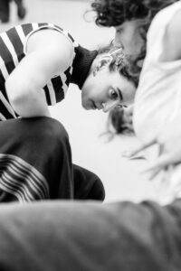 Dancer with focused expression in studio rehearsal, black and white
