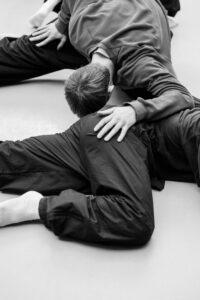 Contemporary dancer in motion during rehearsal in studio, black and white