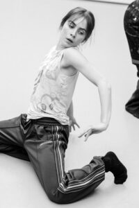 Contemporary dancer in motion during rehearsal in studio, black and white