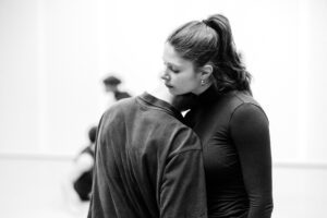 Contemporary dancer in motion during rehearsal in studio, black and white