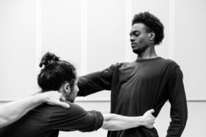 Contemporary dancer in motion during rehearsal in studio, black and white