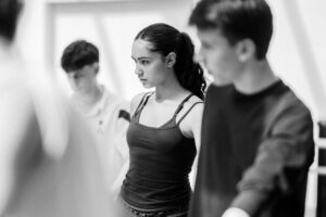 Dancer with focused expression in studio rehearsal, black and white
