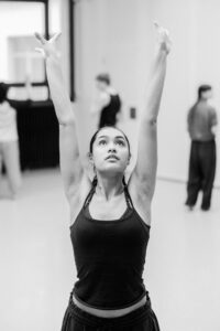 Contemporary dancer in motion during rehearsal in studio, black and white