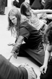 Contemporary dancer in motion during rehearsal in studio, black and white