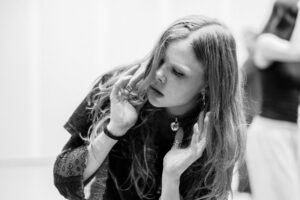 Contemporary dancer in motion during rehearsal in studio, black and white