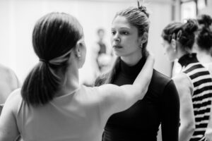 Dancer with focused expression in studio rehearsal, black and white