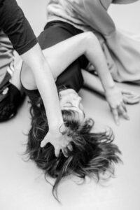 Contemporary dancer in motion during rehearsal in studio, black and white