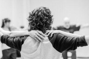 Close-up of dancers’ hands interacting during rehearsal, black and white