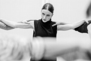 Contemporary dancer in motion during rehearsal in studio, black and white