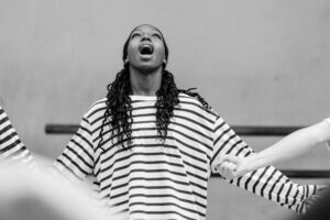 Contemporary dancer in motion during rehearsal in studio, black and white