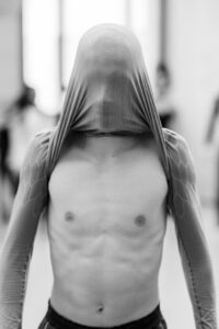 Contemporary dancer in motion during rehearsal in studio, black and white