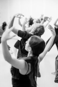 Contemporary dancer in motion during rehearsal in studio, black and white