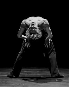 Dancers performing Marco Goecke’s Dark Matter on stage at Theater Basel