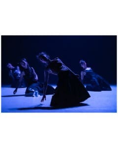 Four dancers kneel in sculptural poses under deep blue light during Land of Hope by Cie Linga.